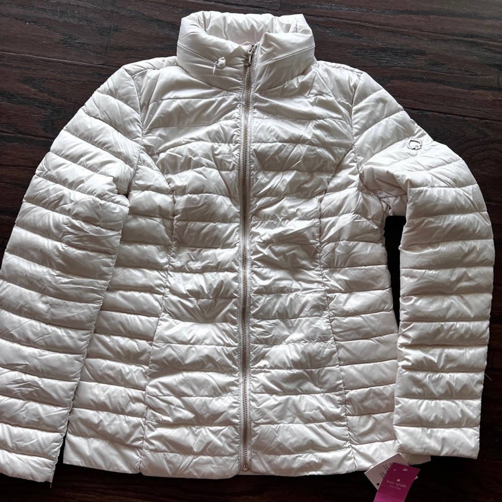 Kate Spade winter puffer jacket. White with pink detail inside. New with tags